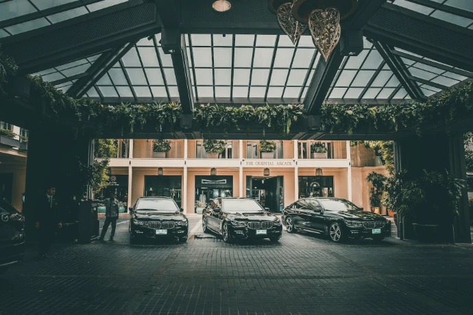 three black cars in a parking lot